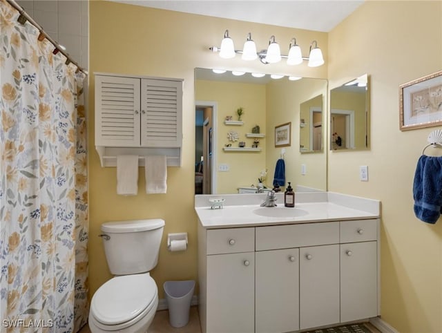 bathroom featuring vanity, toilet, and a shower with shower curtain