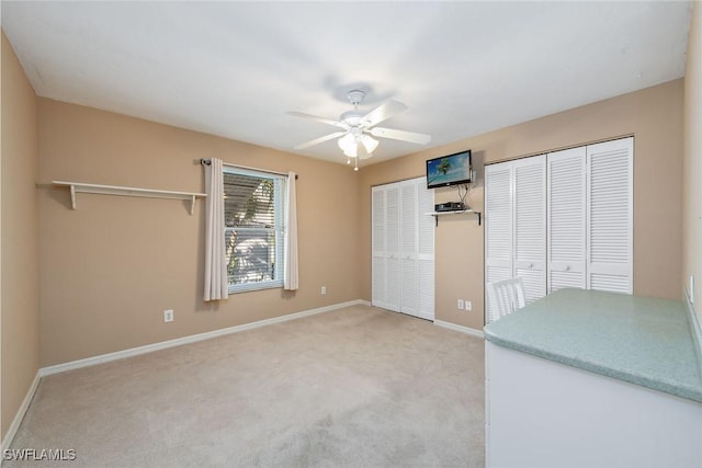 carpeted empty room with ceiling fan