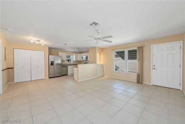 unfurnished living room with light tile patterned floors and ceiling fan