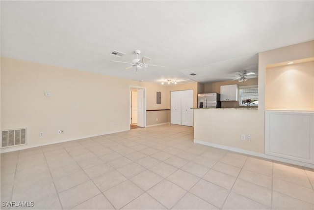 unfurnished living room with light tile patterned flooring and ceiling fan