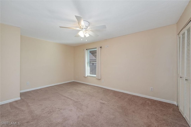 unfurnished room with ceiling fan and light colored carpet