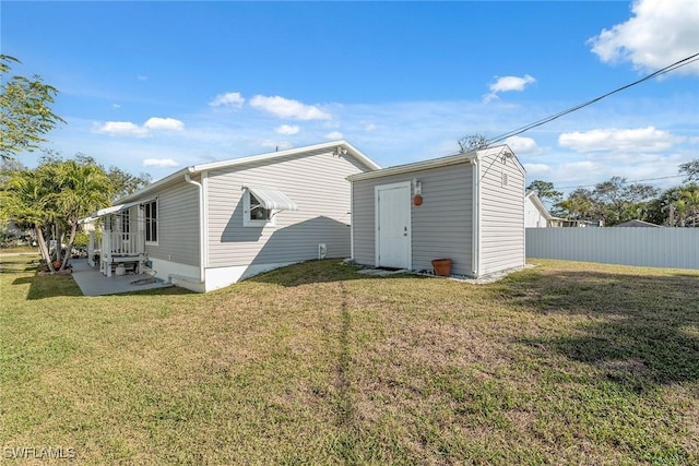 back of property featuring a yard and a patio