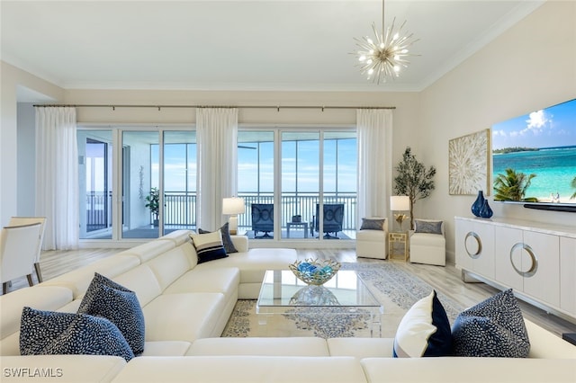 living room with ornamental molding, a notable chandelier, and light hardwood / wood-style flooring