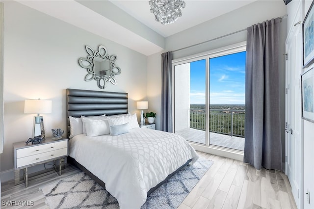 bedroom with light hardwood / wood-style flooring and access to outside