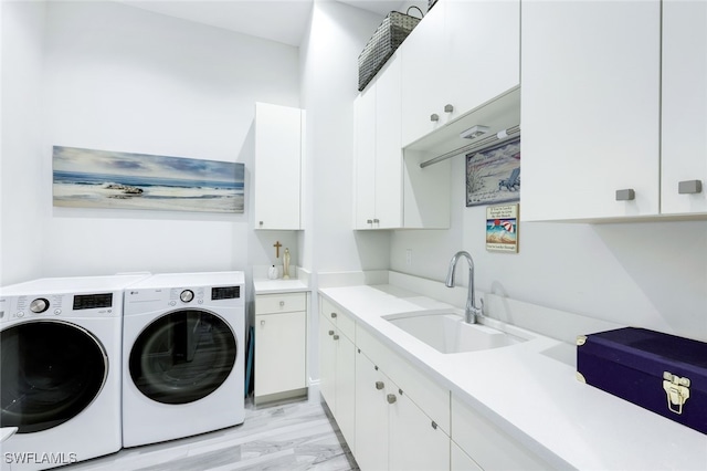 washroom featuring cabinets, sink, and washing machine and clothes dryer