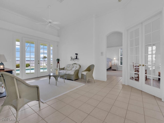 living room with light tile patterned flooring, ceiling fan, and french doors