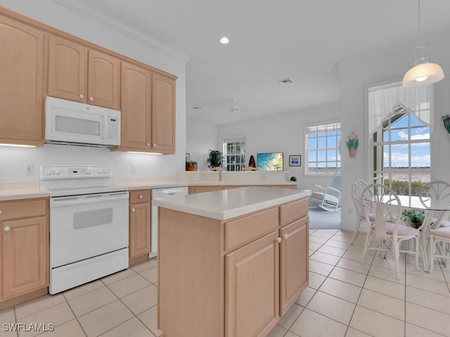 kitchen with white appliances, a center island, and light brown cabinets