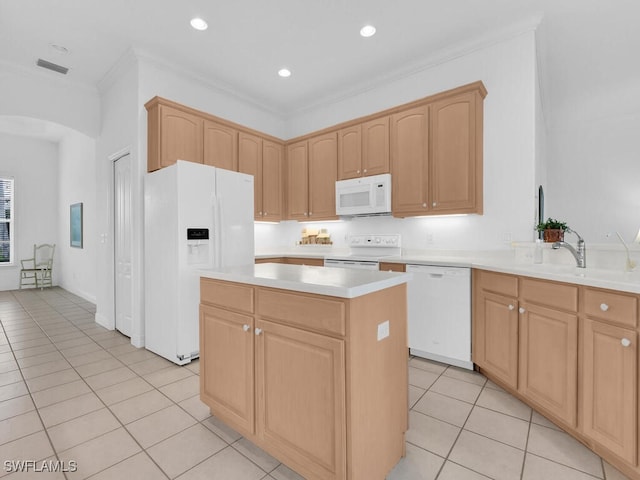 kitchen with white appliances, a center island, light brown cabinets, and light tile patterned floors