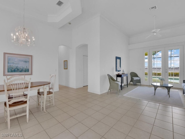 dining room with ornamental molding, a towering ceiling, and light tile patterned floors