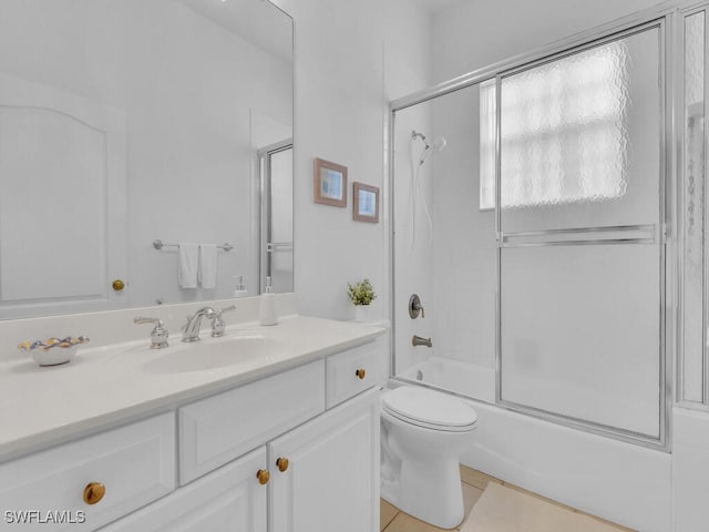 full bathroom featuring vanity, toilet, and combined bath / shower with glass door