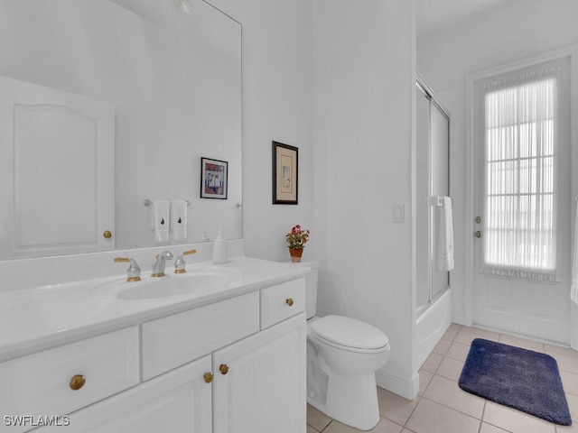 full bathroom featuring vanity, tile patterned floors, enclosed tub / shower combo, and toilet