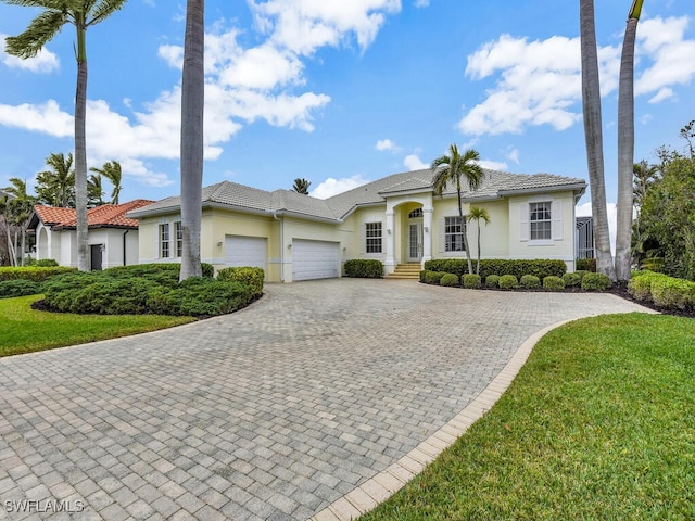 view of front of property with a garage and a front yard