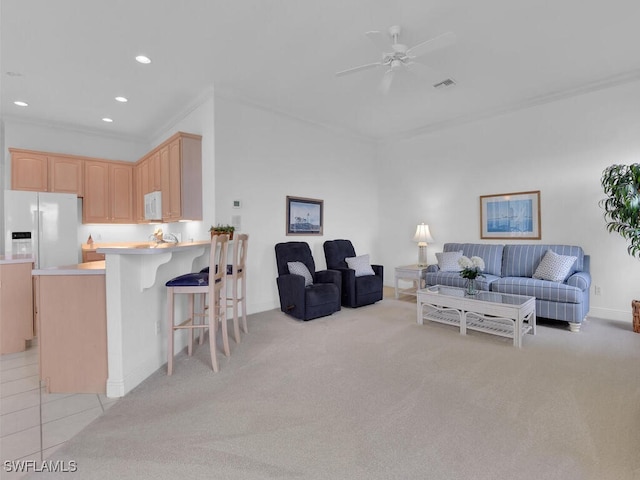 carpeted living room with ornamental molding and ceiling fan