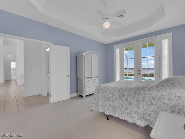 carpeted bedroom with crown molding, ceiling fan, access to exterior, a tray ceiling, and french doors