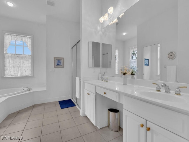 bathroom with tile patterned flooring, vanity, and a bathtub