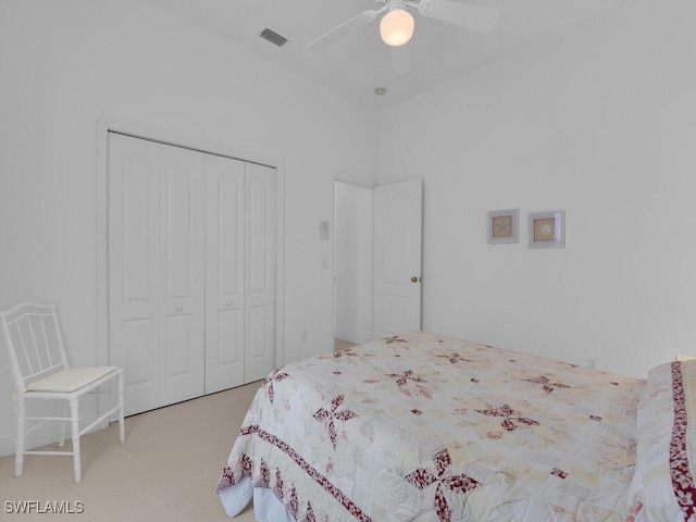 carpeted bedroom with ceiling fan and a closet