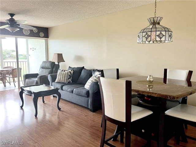 1580 Pine Valley Dr Unit 217, Fort Myers, FL 33907 - dining space featuring a ceiling fan, a textured ceiling, and wood finished floors