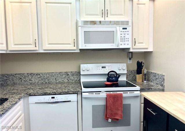 kitchen with white appliances and white cabinets