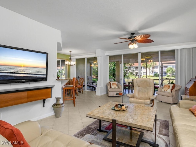 living room with a wealth of natural light, ceiling fan with notable chandelier, and light tile patterned floors