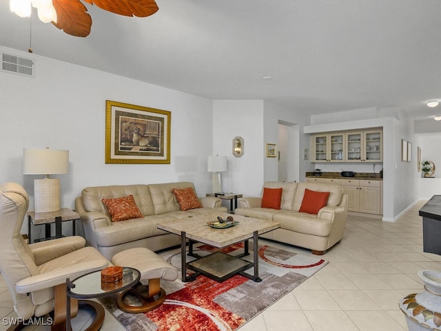 living room featuring light tile patterned flooring and ceiling fan