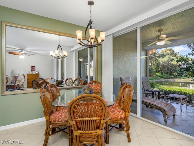 tiled dining room featuring ceiling fan with notable chandelier