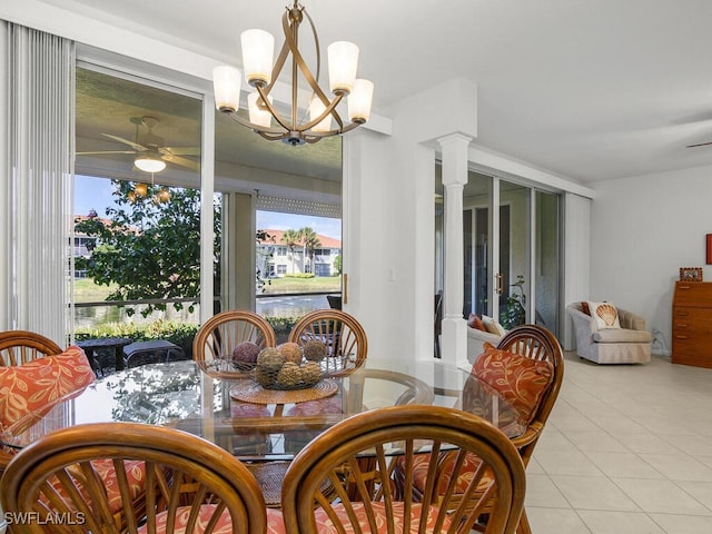 dining room featuring decorative columns, light tile patterned flooring, and ceiling fan with notable chandelier