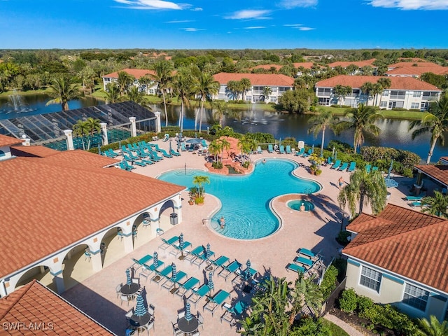 view of pool featuring a water view and a patio area