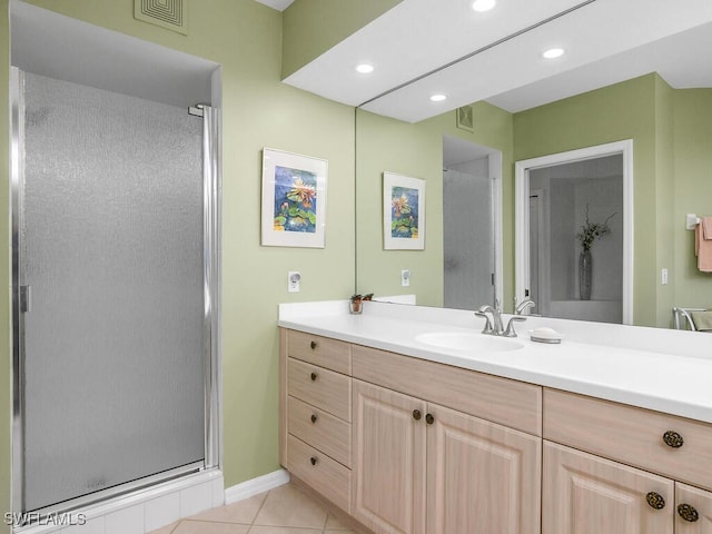 bathroom with tile patterned floors, an enclosed shower, and vanity