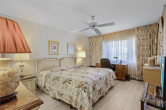 bedroom with ceiling fan and light hardwood / wood-style flooring