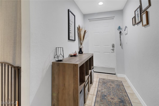 doorway to outside with light tile patterned floors