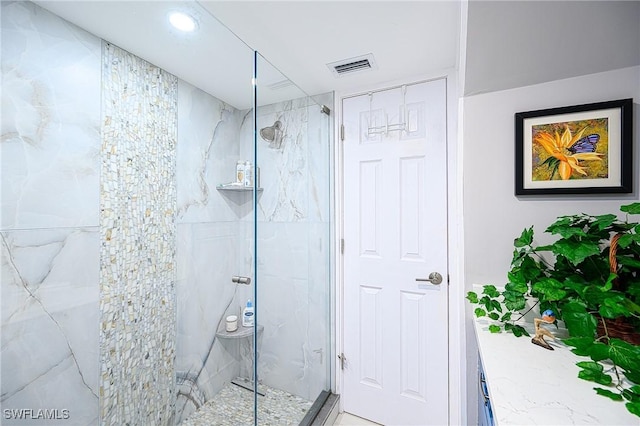 bathroom with a shower with door