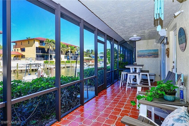 sunroom / solarium with a water view