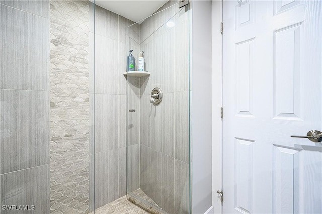 bathroom with tiled shower