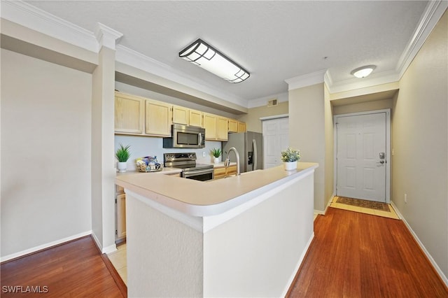 kitchen with crown molding, stainless steel appliances, light hardwood / wood-style floors, and light brown cabinets