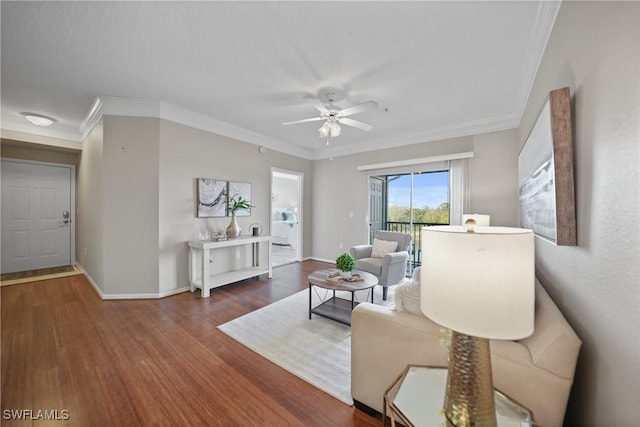 living room featuring ceiling fan, ornamental molding, and dark hardwood / wood-style floors