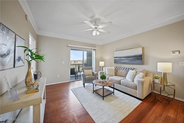 living room with ornamental molding, dark hardwood / wood-style floors, and ceiling fan