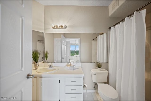 bathroom featuring tile patterned flooring, vanity, and toilet