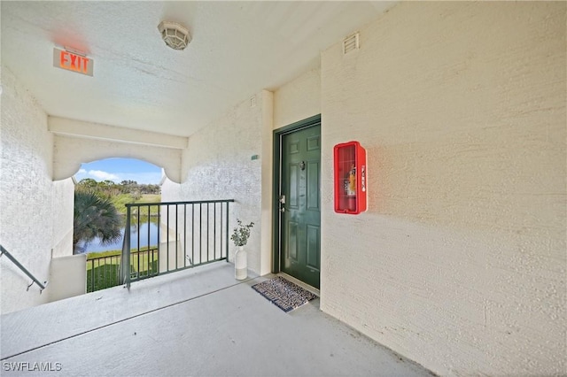 doorway to property with a water view