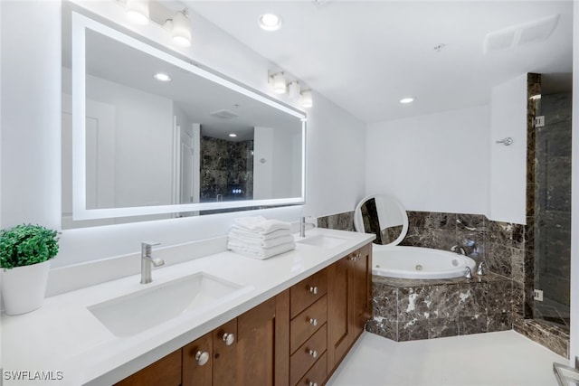 bathroom with vanity and independent shower and bath