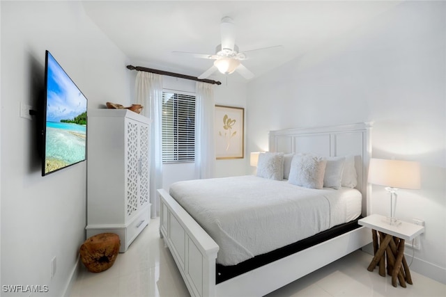 bedroom with ceiling fan and light tile patterned floors