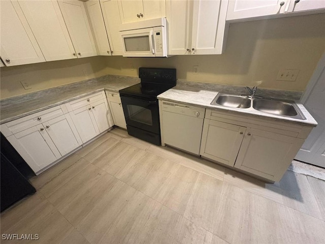 kitchen featuring sink, white cabinets, and white appliances