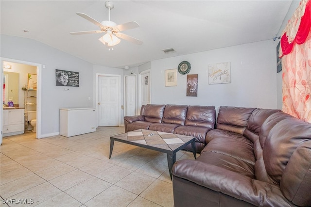 217/219 Ivan Ave S, Lehigh Acres, FL 33973 - living room with light tile patterned flooring, visible vents, vaulted ceiling, a ceiling fan, and baseboards