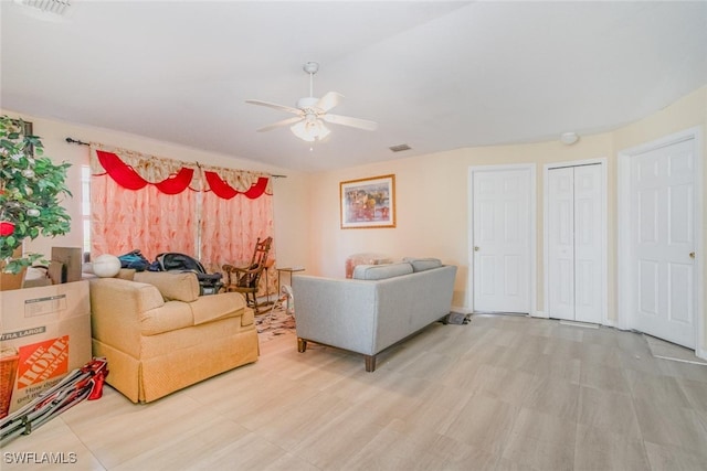 217/219 Ivan Ave S, Lehigh Acres, FL 33973 - living room featuring visible vents and a ceiling fan