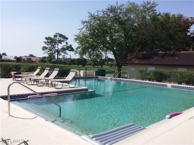 pool with fence and a patio