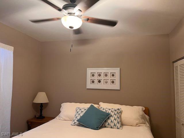 bedroom featuring ceiling fan and a closet