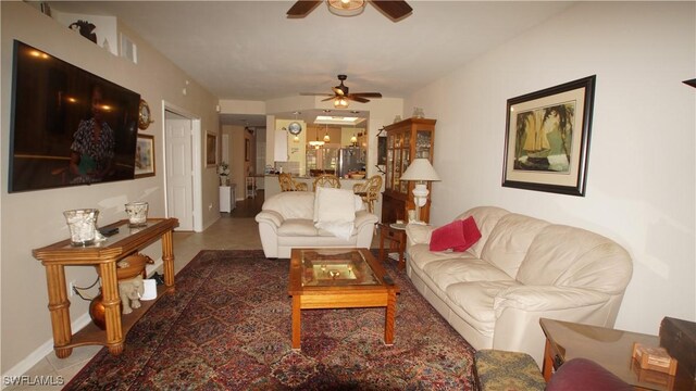 living room featuring ceiling fan and baseboards