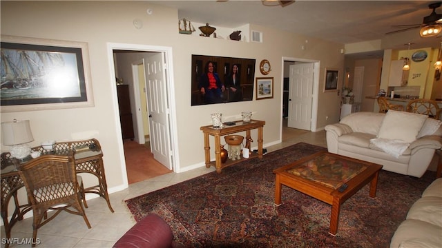 living room featuring a ceiling fan, light tile patterned flooring, visible vents, and baseboards