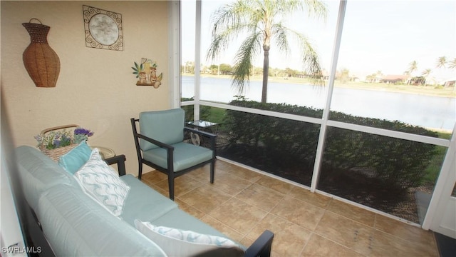 sunroom featuring a water view