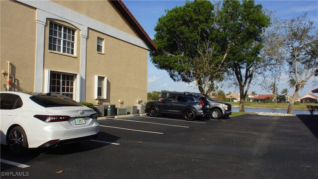 uncovered parking lot with a water view