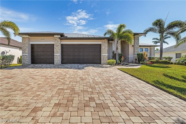 view of front of house with a garage and a front yard